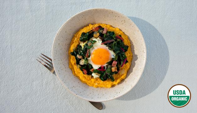 Organic Eggs Nestled in Sautéed Chard Served Over Creamy Polenta 